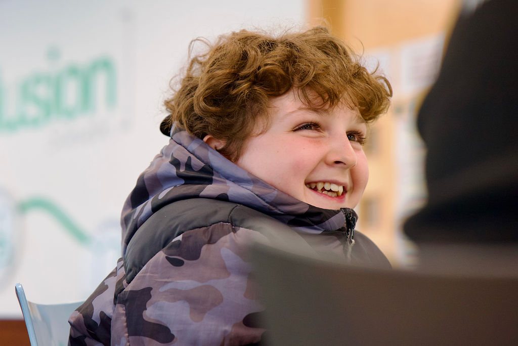 Photo of a pupil at Inclusion education with a smile on their face