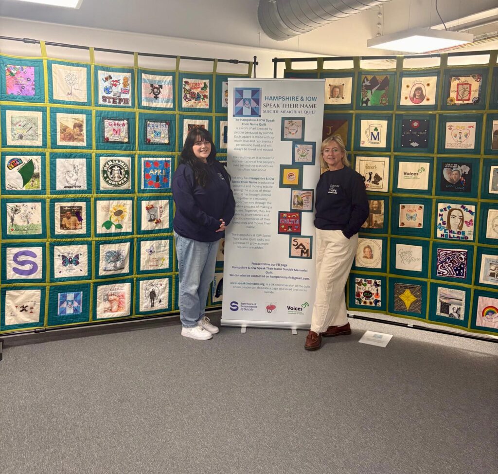 Inclusion Educations Lizzie Allars and Jeanette Hamer with the Hampshire and Isle of Wight Speak Their Name Quilt